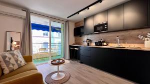 salon z kanapą i kuchnią w obiekcie En plein centre de cannes à 2 pas de la croisette w Cannes