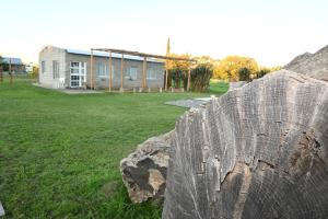 une clôture en bois devant un bâtiment dans l'établissement Aldea Cumelén, à Campos Salles