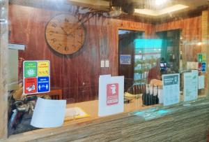 a store window with a clock on the wall at RedDoorz @ near Caticlan Port in Aklan