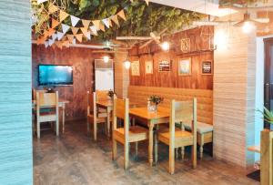 a dining room with a table and chairs and a tv at RedDoorz @ near Caticlan Port in Aklan