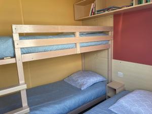 two bunk beds in a room with a bed at Mobil-Home VUE sur MER in Le Portel