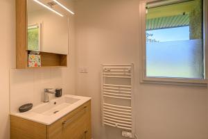 a bathroom with a sink and a window at Les Dryades - Villa familiale proche plage in Sarzeau +20 photos