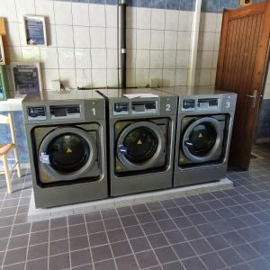 two washing machines sitting next to each other in a room at Mobile home in Boofzheim