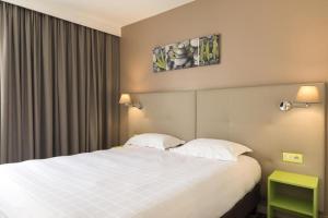 Postel nebo postele na pokoji v ubytování BRIT HOTEL Confort Le Limouzi TULLE