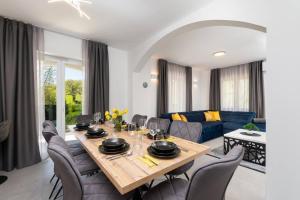 a living room with a wooden table and chairs at Villa Romano by IstriaLux in Benažići