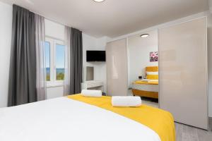 a white bedroom with two beds and a window at Villa Romano by IstriaLux in Benažići +34 photos