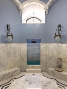 a bathroom with a shower with two sinks and a tub at La Maison Bleue El Gouna in Hurghada