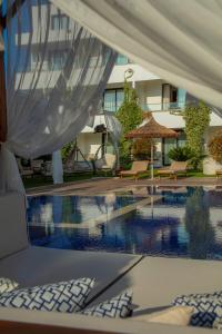 a pool at a hotel with a tent over it at Palmonte Suites Hotel & SPA in Kyrenia