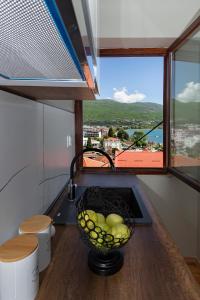 a bowl of fruit in a kitchen with a window at INES APARTMENTS in Ohrid