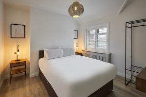 a bedroom with a large white bed and a window at Host & Stay - Holme Rigg in Whitby