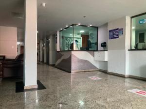 a hallway with a large mirror in a building at Loft da Prainha in Arraial do Cabo +35 photos