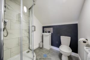 a bathroom with a toilet and a glass shower at Doncaster Large Luxury 3 Bedroom House, Sleeps 8, City Centre, Racecourse, Free Parking, by EMPOWER HOMES in Doncaster