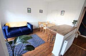 a living room with a blue couch and a table at Contemporary Home in Friendly Easton, Free Parking in Bristol