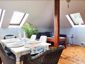 a dining room with a white table and chairs at visit baltic - Villa Blue Marine in Świnoujście