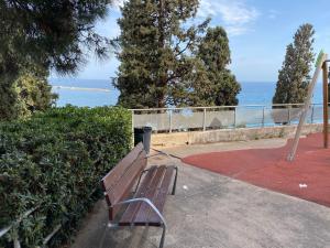 a park bench with a view of the ocean at 3 BDRM APART NEAR THE SEA! GREAT FOR KIDS! in Arenys de Mar