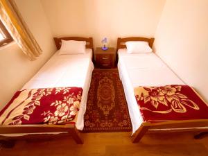 two beds in a small room at Balkan House in Mostar