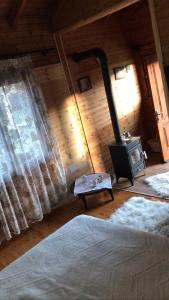 a bedroom with a woodburning stove in a room at Gioia Resort in Voskopojë +10 photos