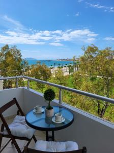 a table and chairs on a balcony with a view of the ocean at SeaLaVita, Modern 2 BR Apartment Sea & Sunset View in Vlorë