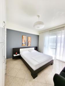 a bedroom with a large white bed in a room at SeaLaVita, Modern 2 BR Apartment Sea & Sunset View in Vlorë