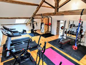 an overhead view of a gym with tread machines at Moulin des ducs grand format by Vindihouses - piscine chaffée - escalade - billard - fitness - etc in Épinac-les-Mines