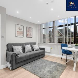 a living room with a couch and a table at Pluxa Larimar - Spacious Apt with Private Entrance, Workspace & Wi-Fi in Harrow
