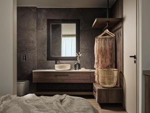 a bathroom with a sink and a mirror at Salita - Comfort Living Apartments in Zakynthos Town