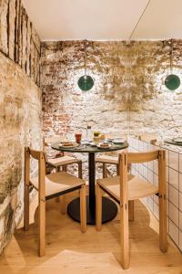 a dining room with a table and two chairs at Hôtel Mathis Elysées in Paris