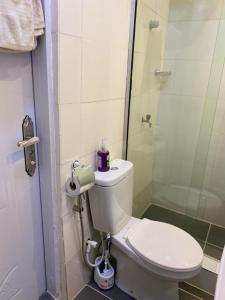 a bathroom with a toilet and a shower at HOUSE 27 HABITAT in Lagos