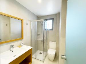 a bathroom with a toilet and a sink and a shower at Melia Sol Art Studios in Karfas