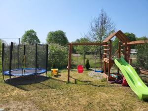 a playground with a slide and a swing set at Gościniec u Zalesia Warchały Noclegi Zalewski in Warchały