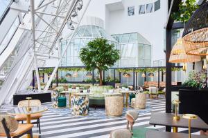 a view of a restaurant with tables and chairs at Leonardo Royal Southampton Grand Harbour in Southampton