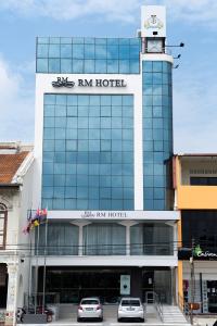 a building with a clock on top of it at RM Hotel in Muar