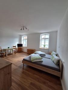 a bedroom with a bed and a living room at Gasthof Adler Ferienwohnung in Ichenhausen