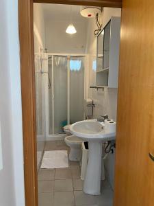 a bathroom with a sink and a toilet and a shower at I Villini in Castellaneta Marina 