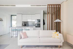 salon z białą kanapą i kuchnią w obiekcie Casa Marbella w mieście Benahavís