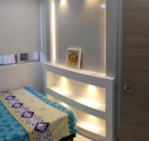 a small room with a small bed with lights at Hermoso Apartamento en Neiva in Neiva
