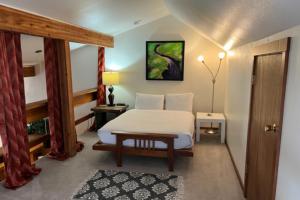 a bedroom with a white bed and a table at Lake Creek 1323 in Wilson