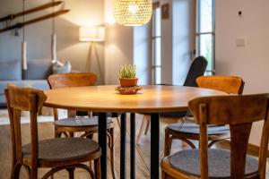 drewniany stół z krzesłami i doniczką w obiekcie Valentin36 Apartment Raschötz w mieście Funes +26 zdjęć