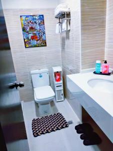 a bathroom with a toilet and a sink at Arthomes BB6 in Mandaue City