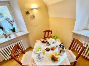 a table with a plate of food on it at Schloss Hotel & Wellness Ering in Ering