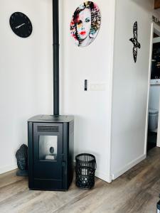 a room with a black stove in the corner of a room at Surla Houseboat "De Albatros" in Monnickendam Tender included in Monnickendam