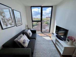 a living room with a couch and a tv at BOLD Apartments - Liverpool City Centre in Liverpool