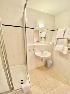 a bathroom with a shower and a sink at Schlosspension Ering in Ering