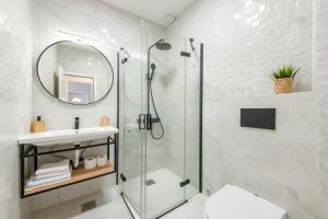 a bathroom with a glass shower and a sink at Villa Doris in Zaton
