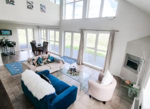 a living room with blue couches and a fireplace at Riverrun Holiday Homes No 15 in Belturbet