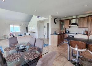 a kitchen and living room with a table and chairs at Riverrun Holiday Homes No 15 in Belturbet