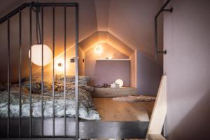 a bedroom with a bed with a crib in it at Rousa little guesthouse Cosy Up in Rasun di Sopra