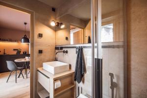 a small bathroom with a sink and a shower at Rousa little guesthouse Cosy Plus in Rasun di Sopra