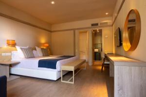 a hotel room with a bed and a mirror at Hotel Santa Marta in Lloret de Mar