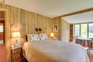 a bedroom with a bed in a room with wooden walls at Serene Salisbury Rental Home on 26 Acres with Deck! in Salisbury